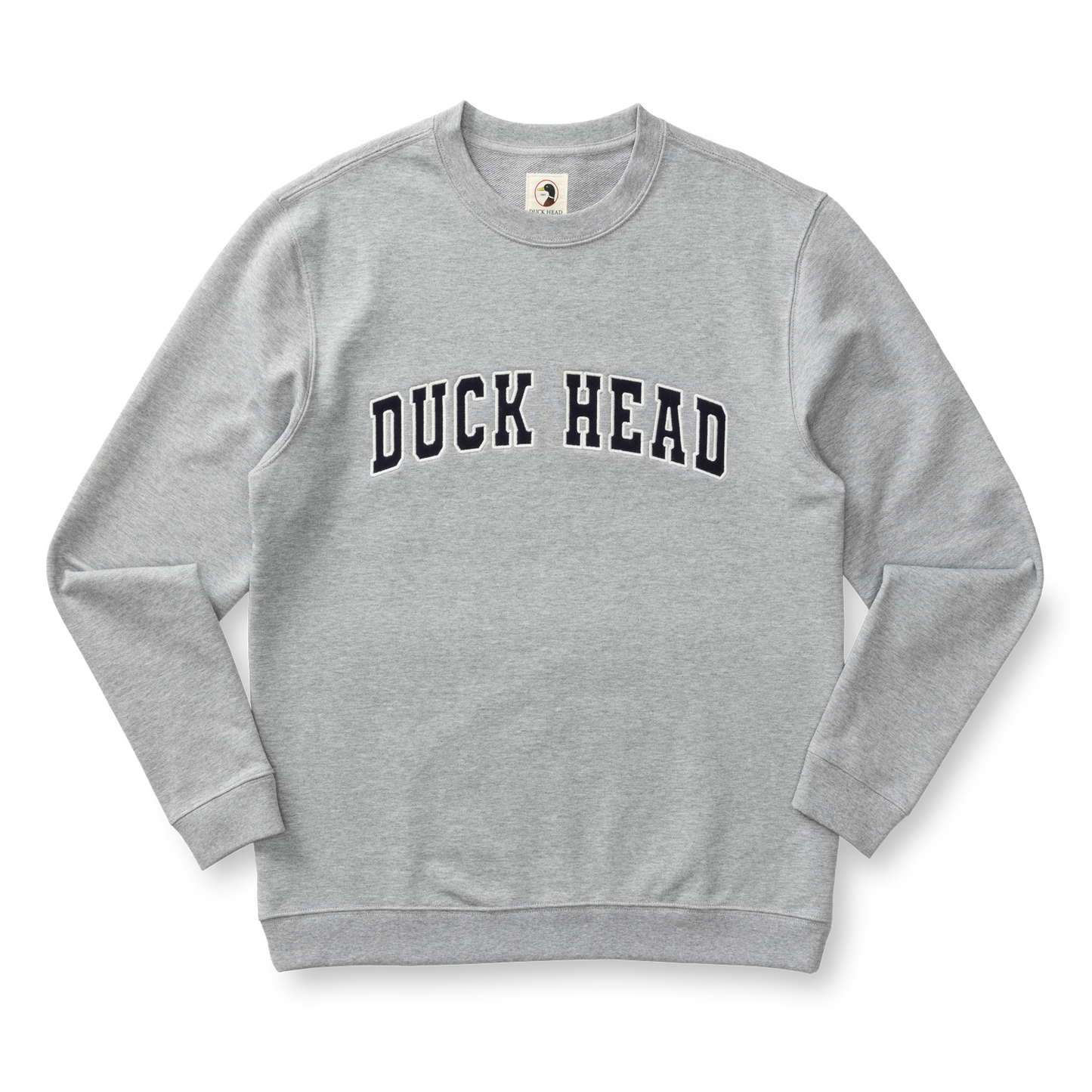 The Duck Head Applique Crewneck Sweatshirt is a light gray cotton crewneck with vintage-style ribbing and bold "DUCK HEAD" lettering across the chest.