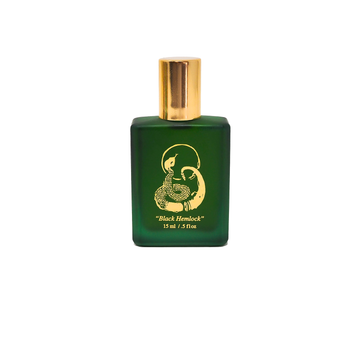 The Black Hemlock perfume by Preservation West comes in a green glass bottle with a gold cap and design, labeled "Black Hemlock, 15 ml / .5 fl oz," featuring fresh garden spearmint notes for an invigorating scent.