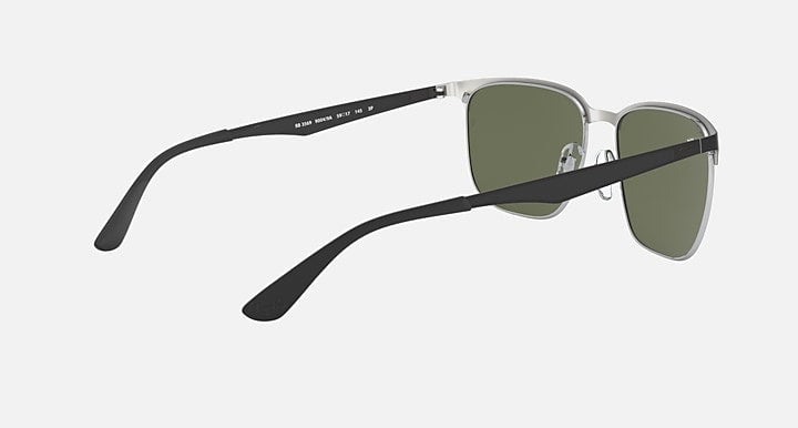 Ray-Ban Black On Silver with Green sunglasses featuring silver frames, black arms, and green lenses, shown from a rear-side angle against a plain light background.