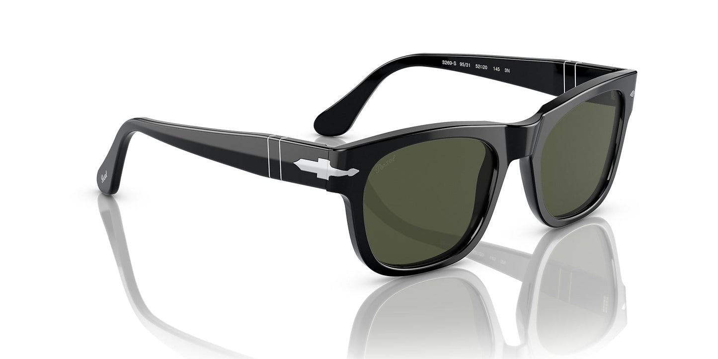 The Persol 0PO3269S Black w/ Green Polar sunglasses feature thick opaline acetate frames, dark lenses, and a signature silver arrow detail on the temples, displayed on a white reflective surface to highlight their retro style.