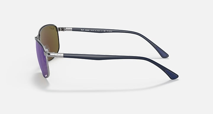 Side view of Ray-Ban Chromance sunglasses in Blue on Gunmetal with Polar Grey Mirror Blue lenses, featuring thin metal arms and blue plastic temple tips, set against a plain light background.