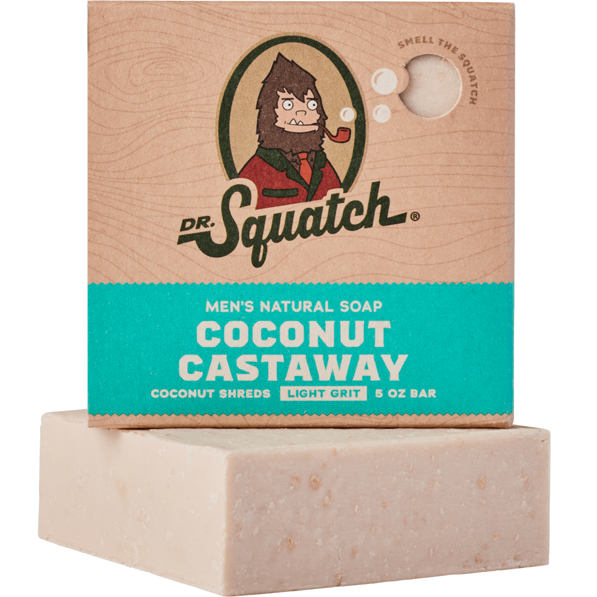 A bar of Dr.Squatch Coconut Castaway Soap, featuring packaging with a cartoon character and product details, rests atop an unwrapped soap bar as the soothing scent of toasted coconut drifts through the air.