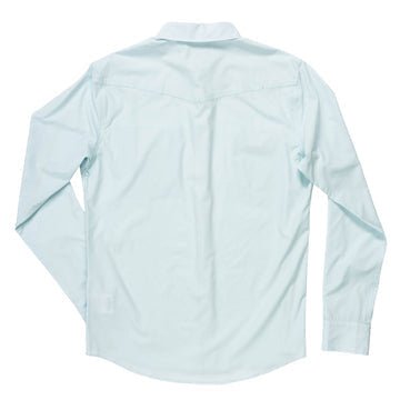 The Confluence Tech Shirt by Sendero Provisions Co. in Matagorda Sky is a light blue, tailored fit, long sleeve button-down shown from the back.