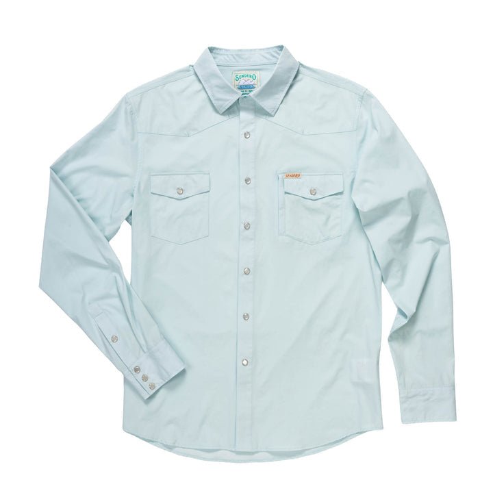 The Sendero Provisions Co. Confluence Tech Shirt in Matagorda Sky features a tailored fit, long sleeves, two chest pockets, and a small logo tag above the left pocket, shown laid flat on a white background.