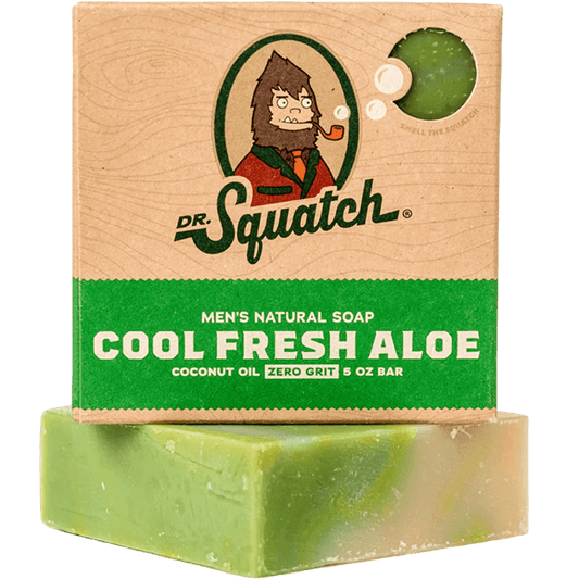 Dr. Squatch Cool Fresh Aloe Soap (5 oz) is a men’s natural, zero-grit bar with deep-cleaning coconut oil, in green and beige packaging featuring a cartoon character smoking a pipe.