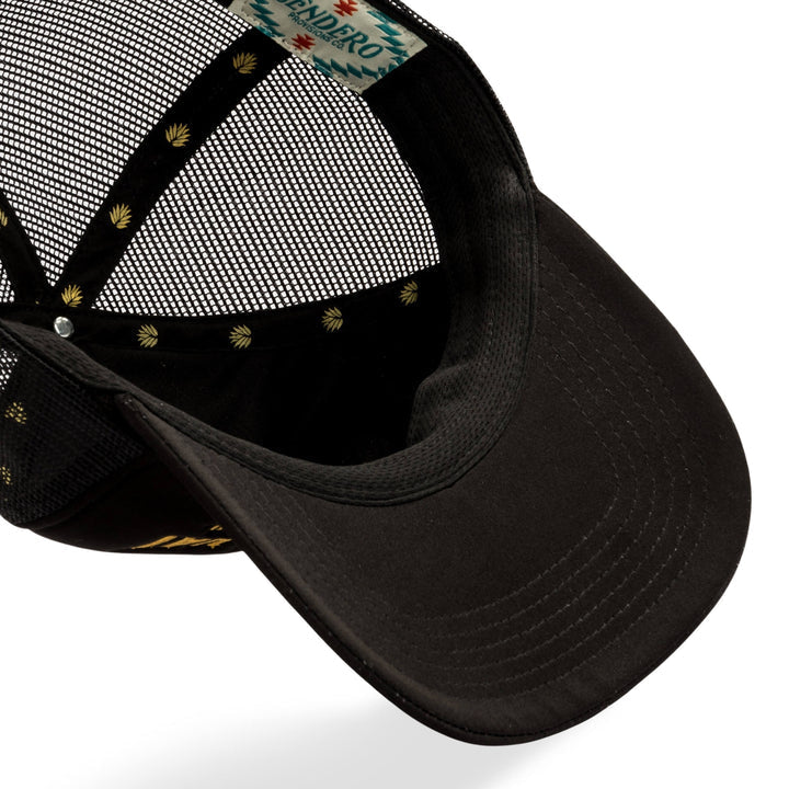 The Cowboy Hat by Sendero Provisions Co. is shown from above, featuring its inner lining, printed label, and decorative brim pattern—a stylish mesh trucker hat for all.