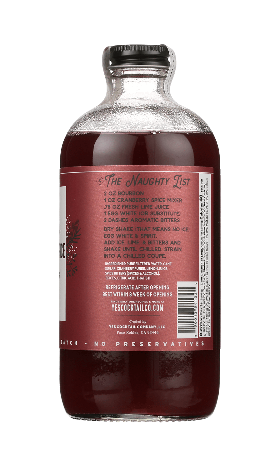 A clear glass bottle from Yes Cocktail Co. contains Cranberry Spice—a dark red mixer infused with festive mulling spices. The label displays a cocktail recipe and product info, making it the perfect holiday cocktail mixer.