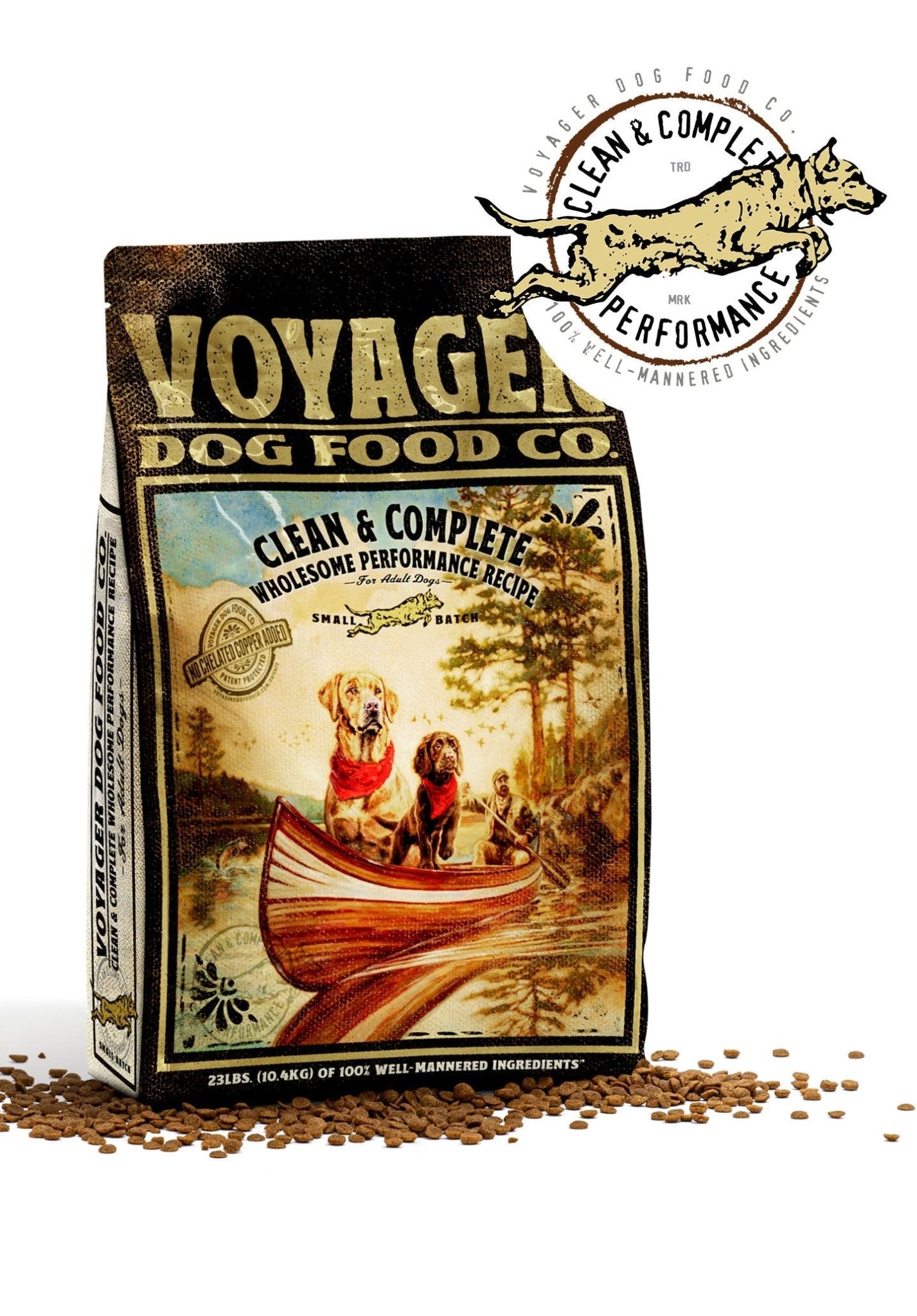 A bag of Voyager Dog Food Co. Dog Food shows two dogs in a canoe on a lake, scattered kibble, and a round "Clean & Complete" logo in the corner.