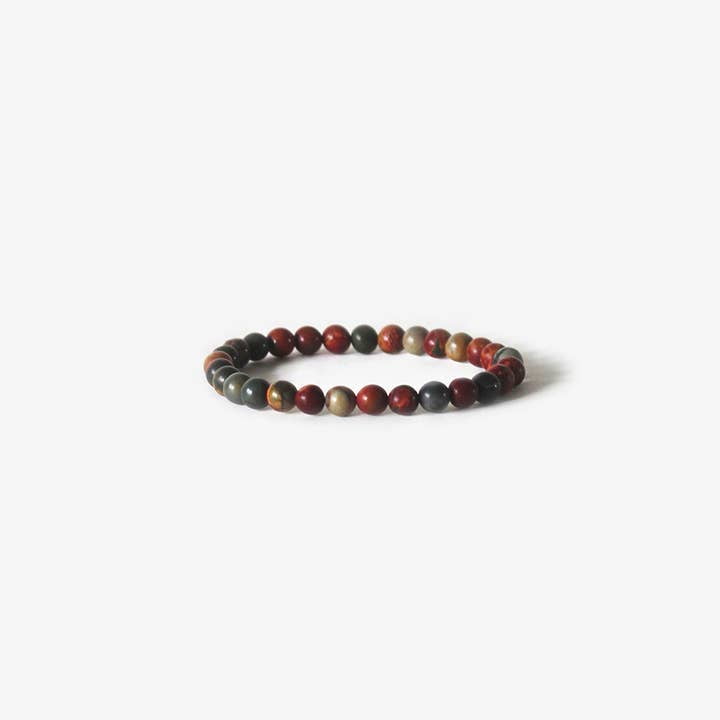 The Earth Bracelet - Picasso Jasper by BRANCO features round Picasso jasper beads in red, brown, and gray tones, displayed on a white background.