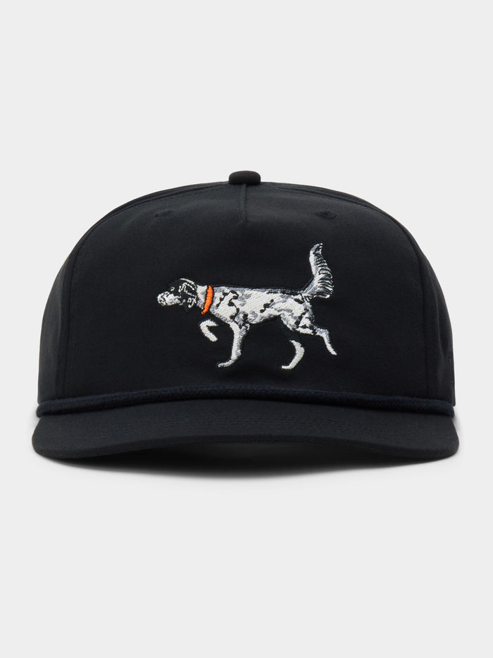 The English Setter Hat by Duck Camp is a black snapback cap with an embroidered white dog and orange collar on the front. Adjustable and made from durable polyester, it offers comfort and style for everyday wear.