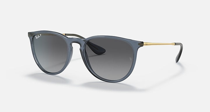 A pair of Ray-Ban Erika sunglasses with transparent blue frames, grey gradient polarized lenses, and 100% UV protection.