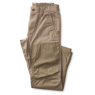 A pair of Field Canvas Briar Pant by Duck Head in khaki, featuring reinforced abrasion-resistant knee patches, is folded neatly on a white background.