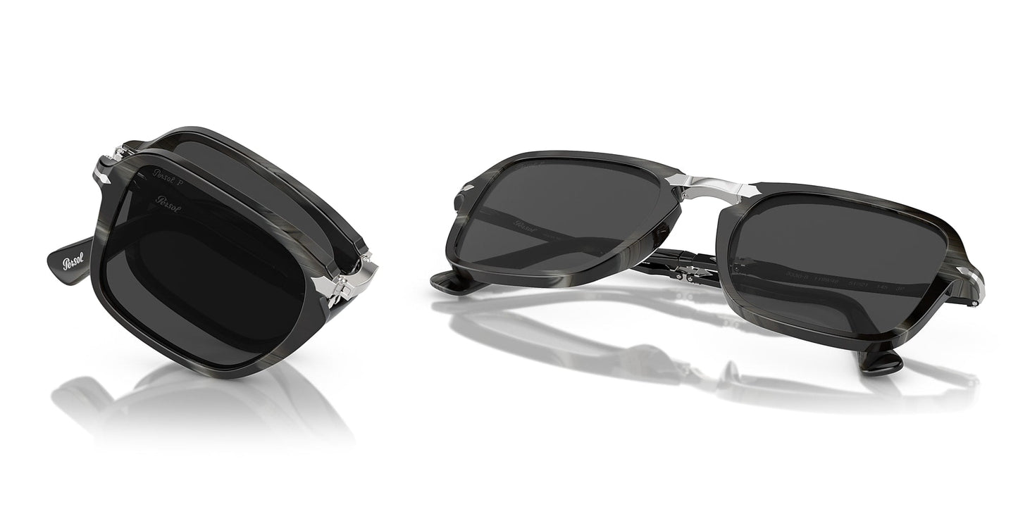 Two pairs of Persol Folding Black Horn w/ Polar Black sunglasses (0PO3330S) are shown—one folded, one open—with sleek, classic 649-inspired design reflected on a white surface.