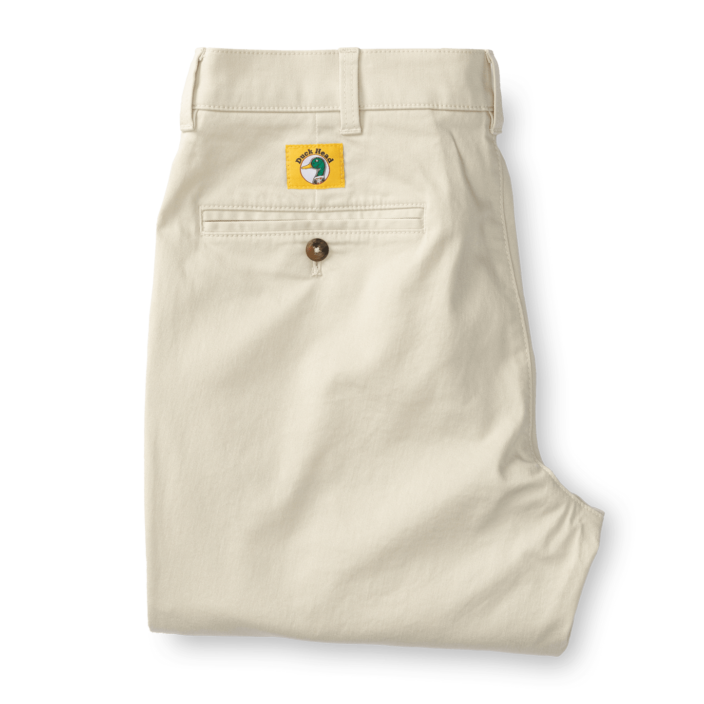 A pair of folded Duck Head Gold School Chino (Big Gold Patch) khakis with a single back pocket, brown button, and signature yellow patch—classic American heritage style.