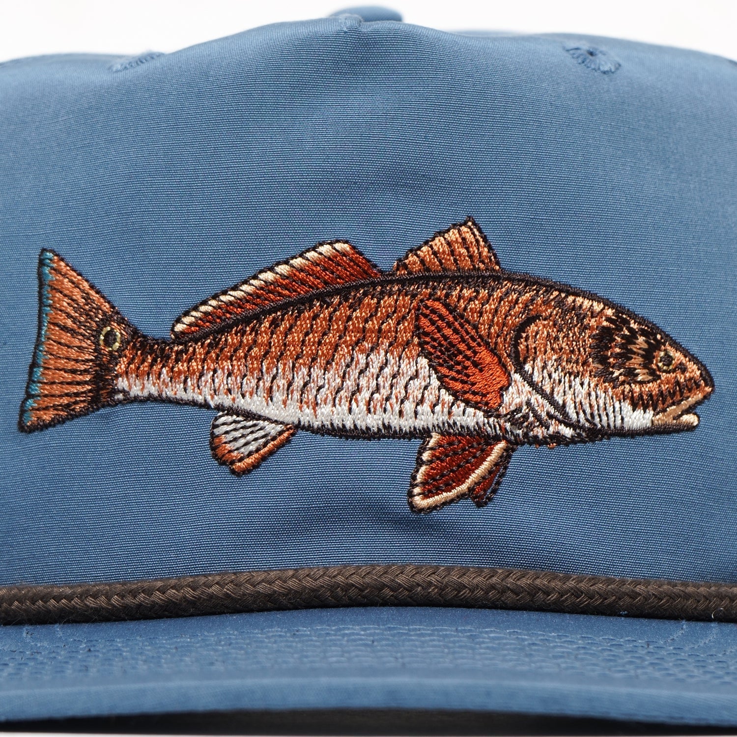 The Duck Camp Grandpa Hat | Redfish features a blue adjustable fit and an embroidered brown and white redfish, perfect for fishing enthusiasts seeking both style and comfort.