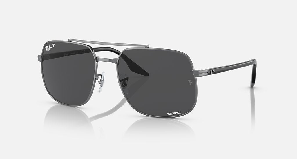 Ray-Ban Gunmetal with Dark Grey sunglasses feature a sculpted metal frame, dark tinted lenses, and adjustable nose pads, presented on a plain light background.