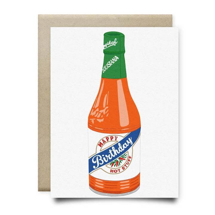 The "Happy Birthday Hot Stuff Crystal" card by Anvil Cards features a Louisiana hot sauce bottle illustration and "Happy Birthday Hot Stuff" message, printed on sustainable linen paper. Handmade A2 card from Houston.