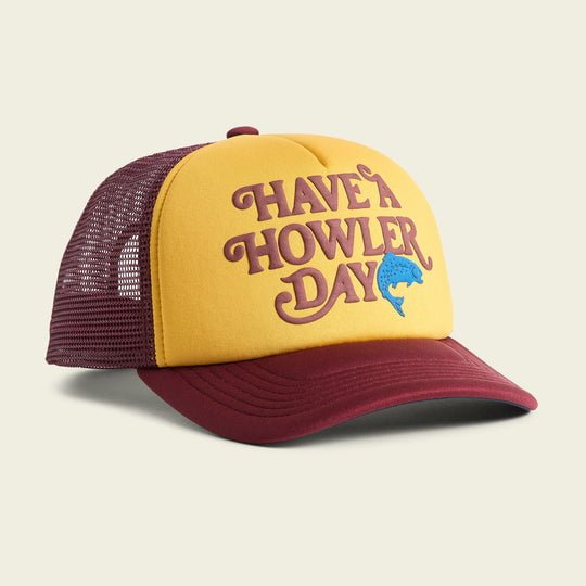 The Have a Howler Day Foam Dome by Howler Brothers is a vintage-style yellow and maroon mesh trucker hat with a foam front, featuring “HAVE A HOWLER DAY” and a blue fish graphic on its high crown.
