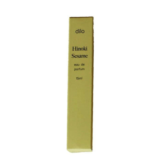 A rectangular box labeled "Hinoki Sesame Eau De Parfum | dilo" stands upright against a white background, evoking the rich scent of hinoki, sesame, and sandalwood.