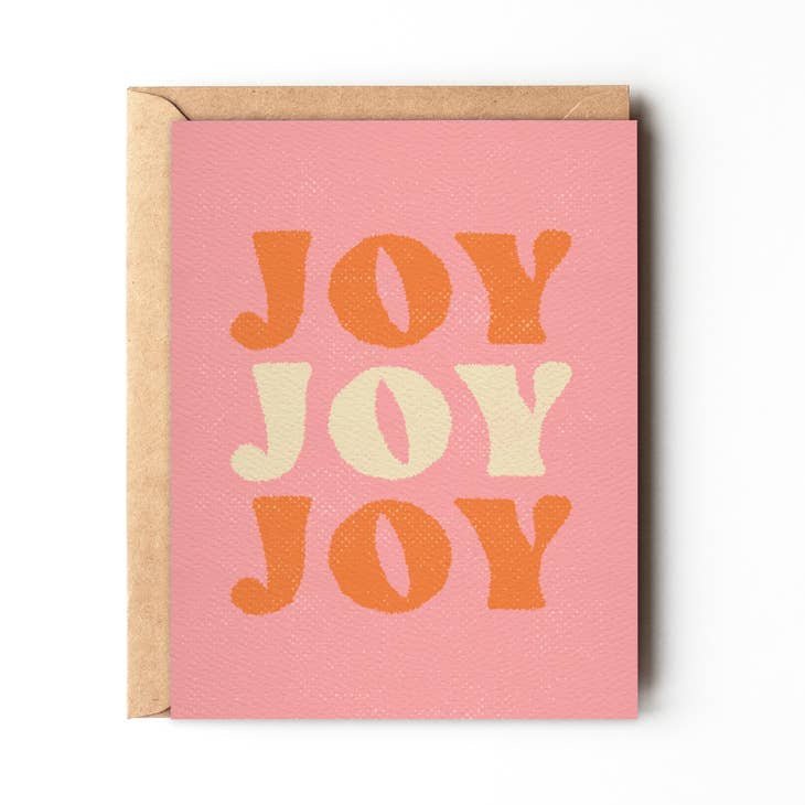 The Joy Joy Joy holiday card by Daydream Prints features "JOY" three times in bold, textured orange and cream seventies font for a retro California beach vibe.
