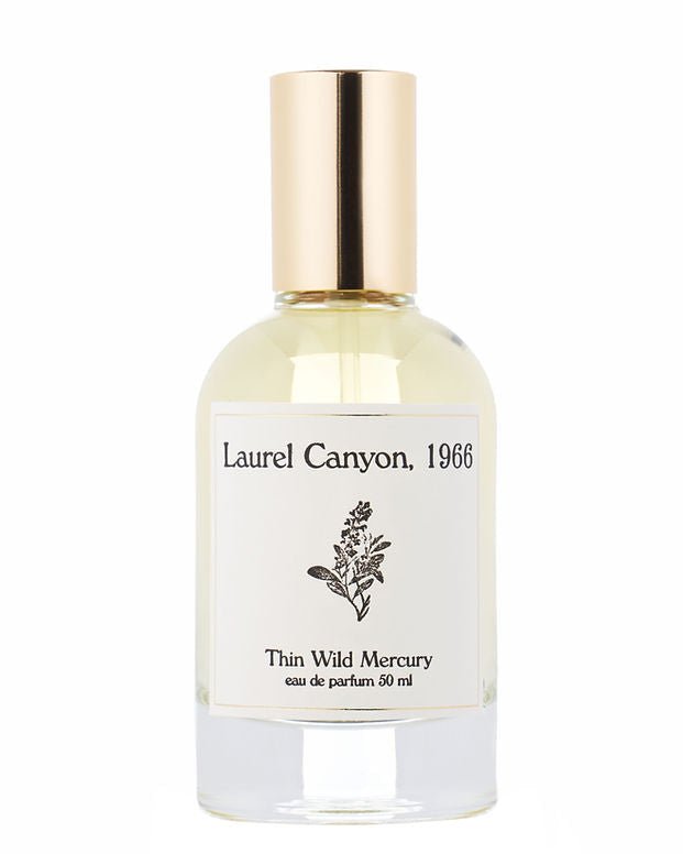 A clear glass perfume bottle with gold cap, labeled "Laurel Canyon | Thin Wild Mercury" by Thin Wild Mercury, 50ml eau de parfum, features a small botanical illustration and captures the scent of woody canyon air and acoustic guitar echoes.