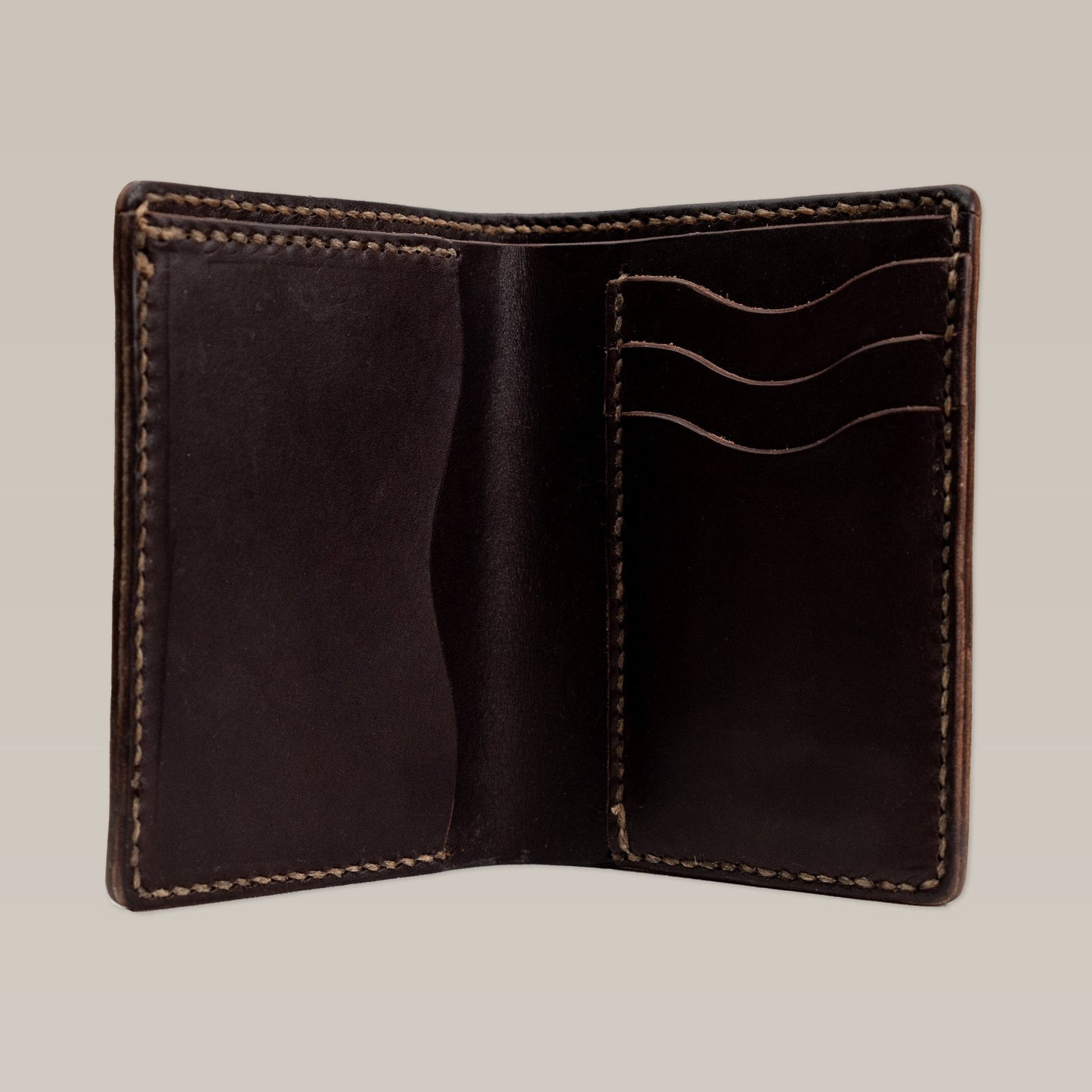 The Leather Wallet | Bi-Fold by Ballad of the Bird Dog is an open dark brown leather wallet with visible stitching, three card slots, and an empty left pocket.