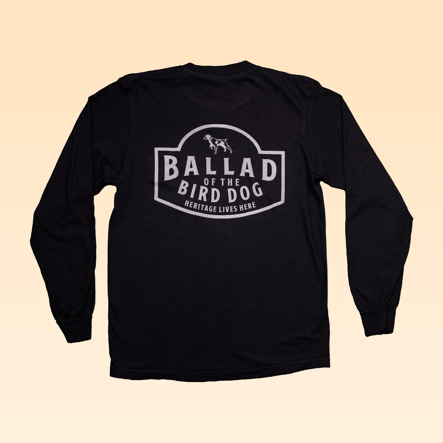 The Long Sleeve Pocket Shirt | Heritage Lives Here by Ballad of the Bird Dog features a dog graphic on the back and quality craftsmanship for a classic tee feel.