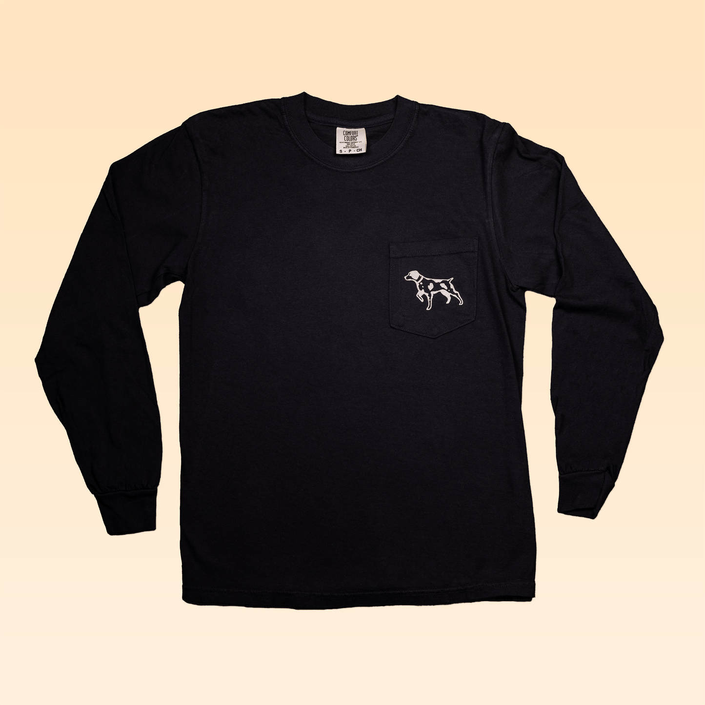 The Long Sleeve Pocket Shirt | Heritage Lives Here by Ballad of the Bird Dog features a chest pocket with a white outline dog design and is showcased on a light beige background.