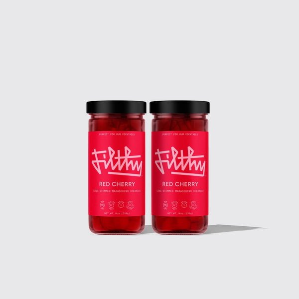 Two glass jars with black lids contain Filthy Long Stemmed Maraschino Cherries. Each jar features a bright red label with bold white text—a perfect cocktail garnish from the Filthy brand.