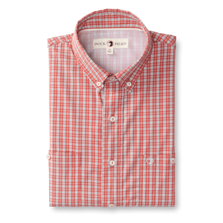 The Duck Head Ls Performance Poplin Guide Shirt features a red and white checkered pattern, button-down collar, chest pocket, and quick-drying fabric—ideal for your next outdoor adventure.