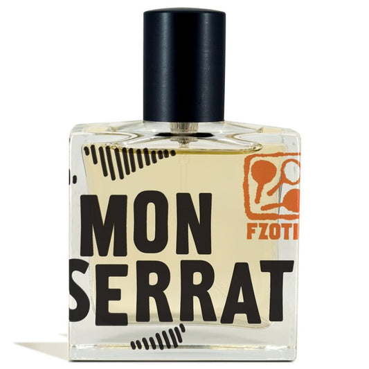 A clear glass perfume bottle labeled "Monserrat | Fzotic" features a black cap and orange accents. The light yellow liquid suggests juicy grapefruit notes, capturing a Mediterranean vibe and sunlit seaside days.
