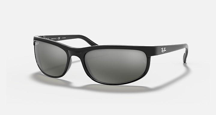 The Ray-Ban Predator 2 sunglasses feature a sporty black wraparound frame, dark grey lenses, Predator temple tips, and the Ray-Ban logo on the temples. Shown in the classic RB2027 design against a white background.