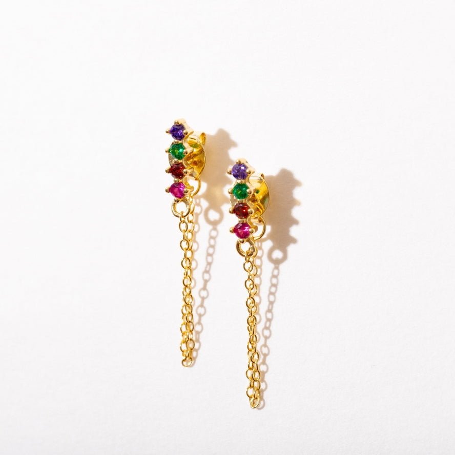 The Rainbow Chain Loop Studs by Larissa Loden are gold plated sterling silver drop earrings with multicolored gemstones, shown on a white background. Hypoallergenic and perfect for sensitive ears.