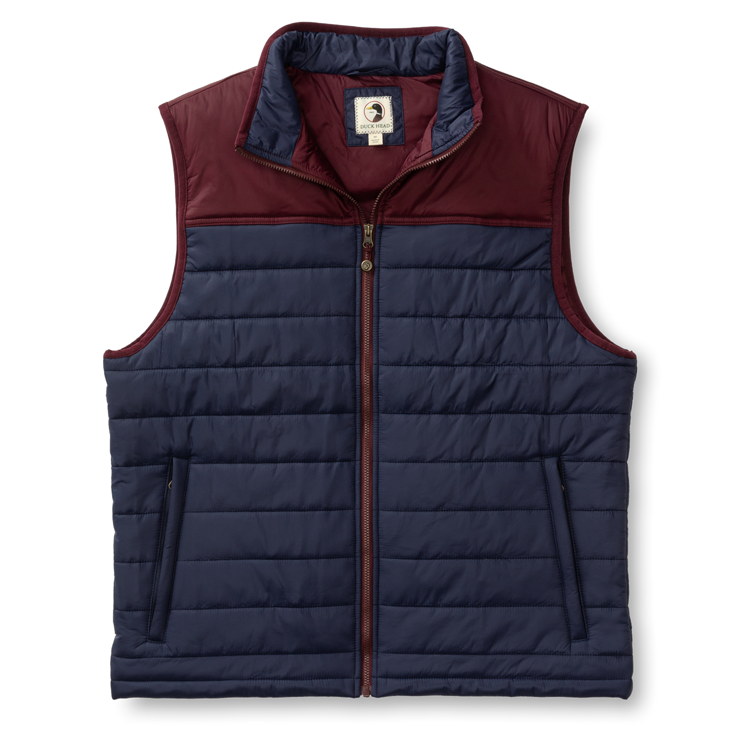 The Duck Head Ridgeland Performance Quilted Vest is lightweight and sleeveless with PrimaLoft insulation, a navy body, maroon yoke and collar, zip front closure, and is shown on a plain white background.