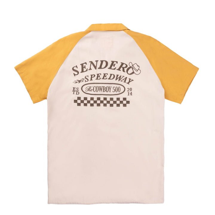 The Saloon Shirt by Sendero Provisions Co. is a classic-fit, vintage two-tone short-sleeve shirt with yellow sleeves, cream back, racing graphics, and "Sender Speedway The Cowboy 500 2014" text. Made from soft Tencel cotton for comfort.