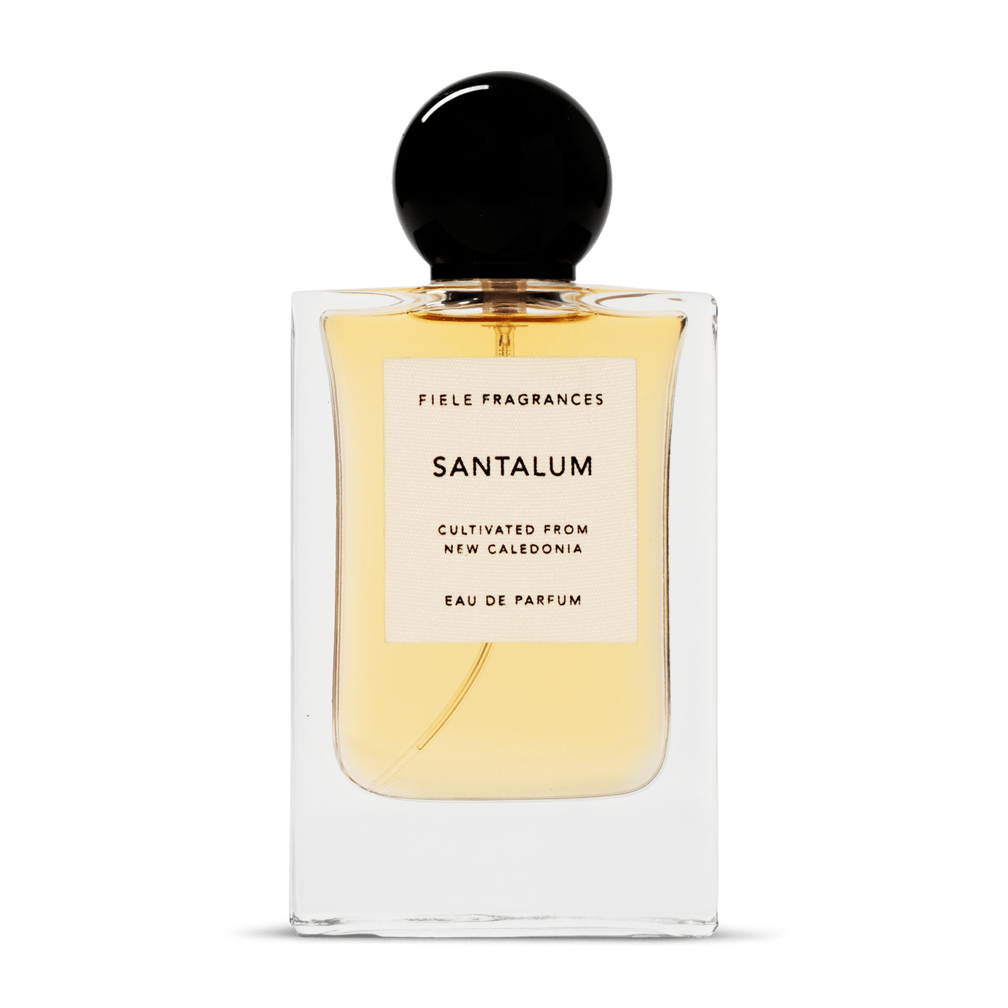A clear glass bottle with a black cap holds yellow liquid. The label reads: "Santalum | Fiele Fragrances" by Fiele Fragrance, a vegan, cruelty-free eau de parfum.