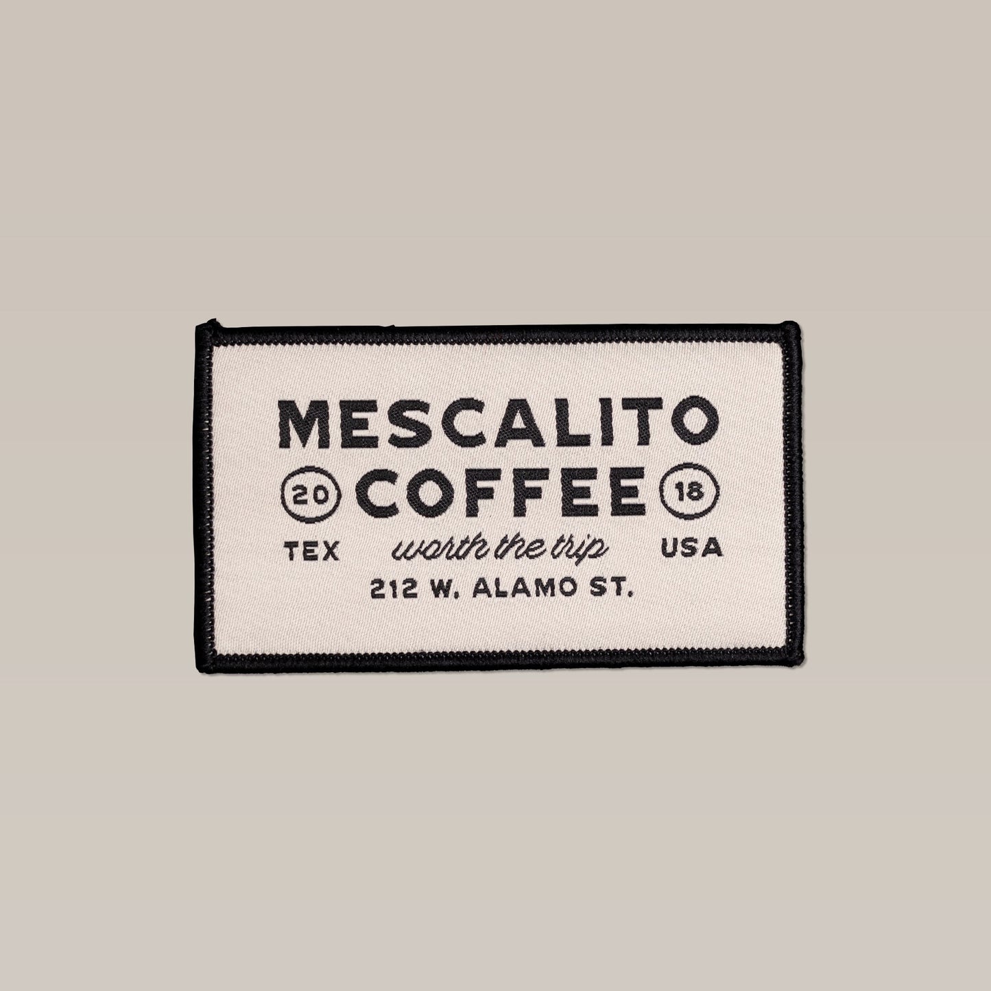 A rectangular beige patch with a black border featuring the "Mescalito Coffee" logo, text "Worth the trip, 212 W. Alamo St., TEX, USA, 2018." Product: Shop Patch | Rectangle Logo Mescalito by Ballad of the Bird Dog.
