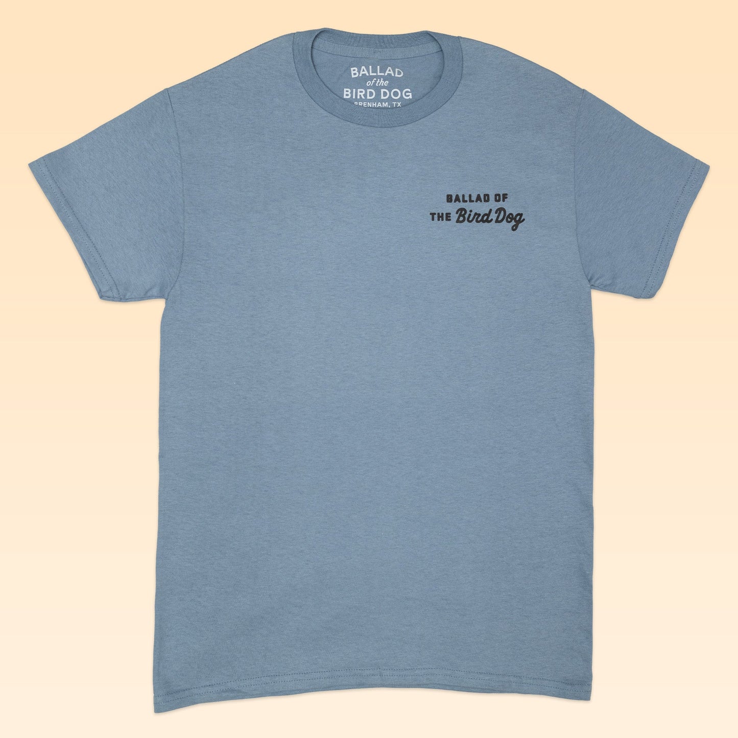 The Shop Shirt | AZ to TX Journey by Ballad of the Bird Dog features a light blue color and small black "BALLAD OF THE BIRD DOG" text on the left chest, inspired by classic Brenham, TX shirt styles.