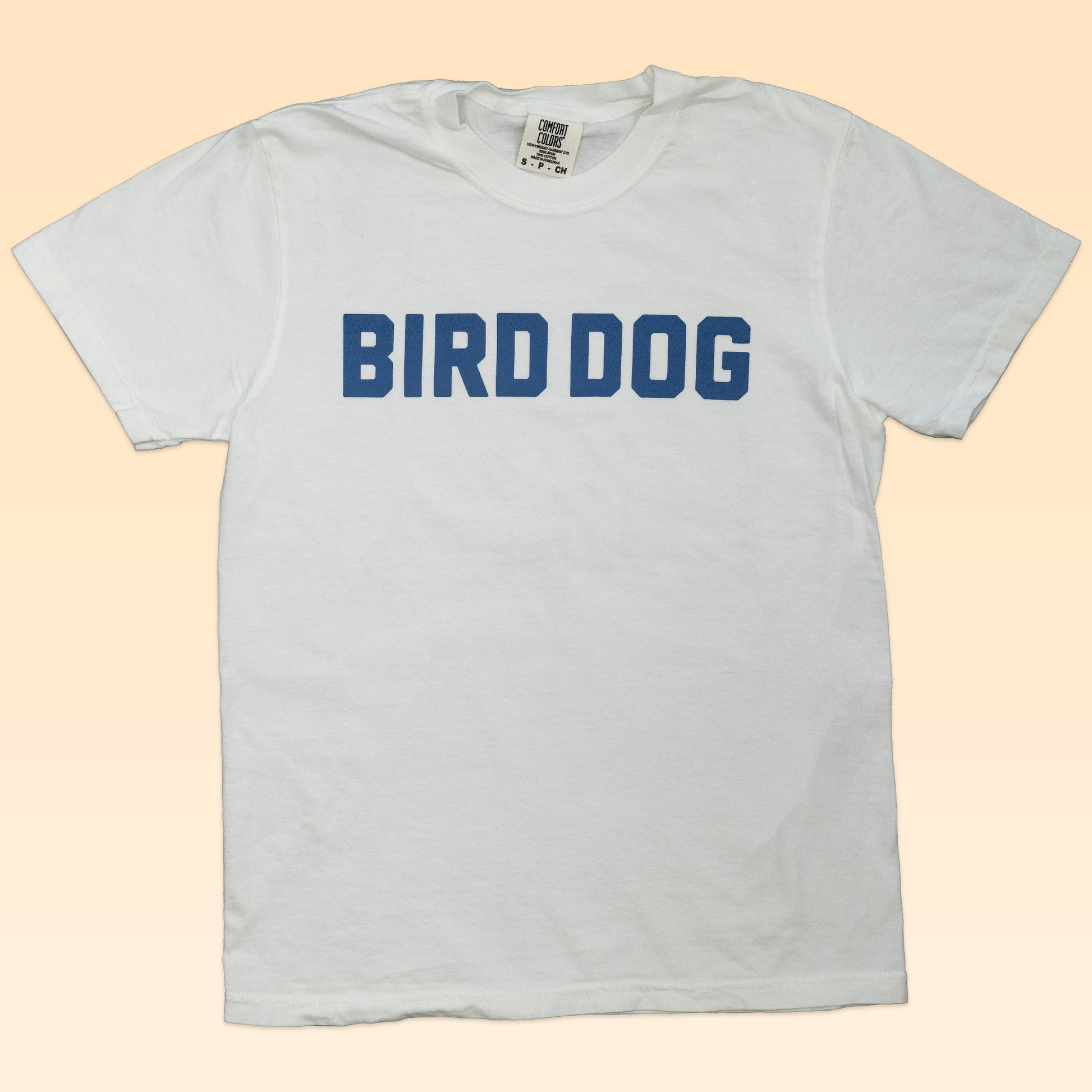 The Shop Shirt | Bird Dog Honor by Ballad of the Bird Dog features bold blue "BIRD DOG" lettering—ideal for fans of classic hunting dog style.