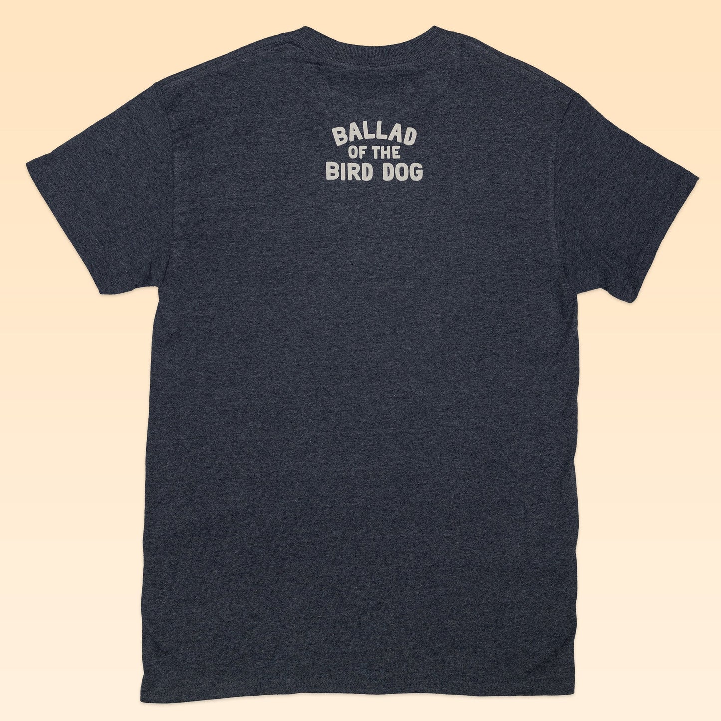 A dark gray Shop Shirt by Ballad of the Bird Dog, shown from the back with "Ballad of the Bird Dog" printed in white near the neckline—a nod to small town Texas charm.