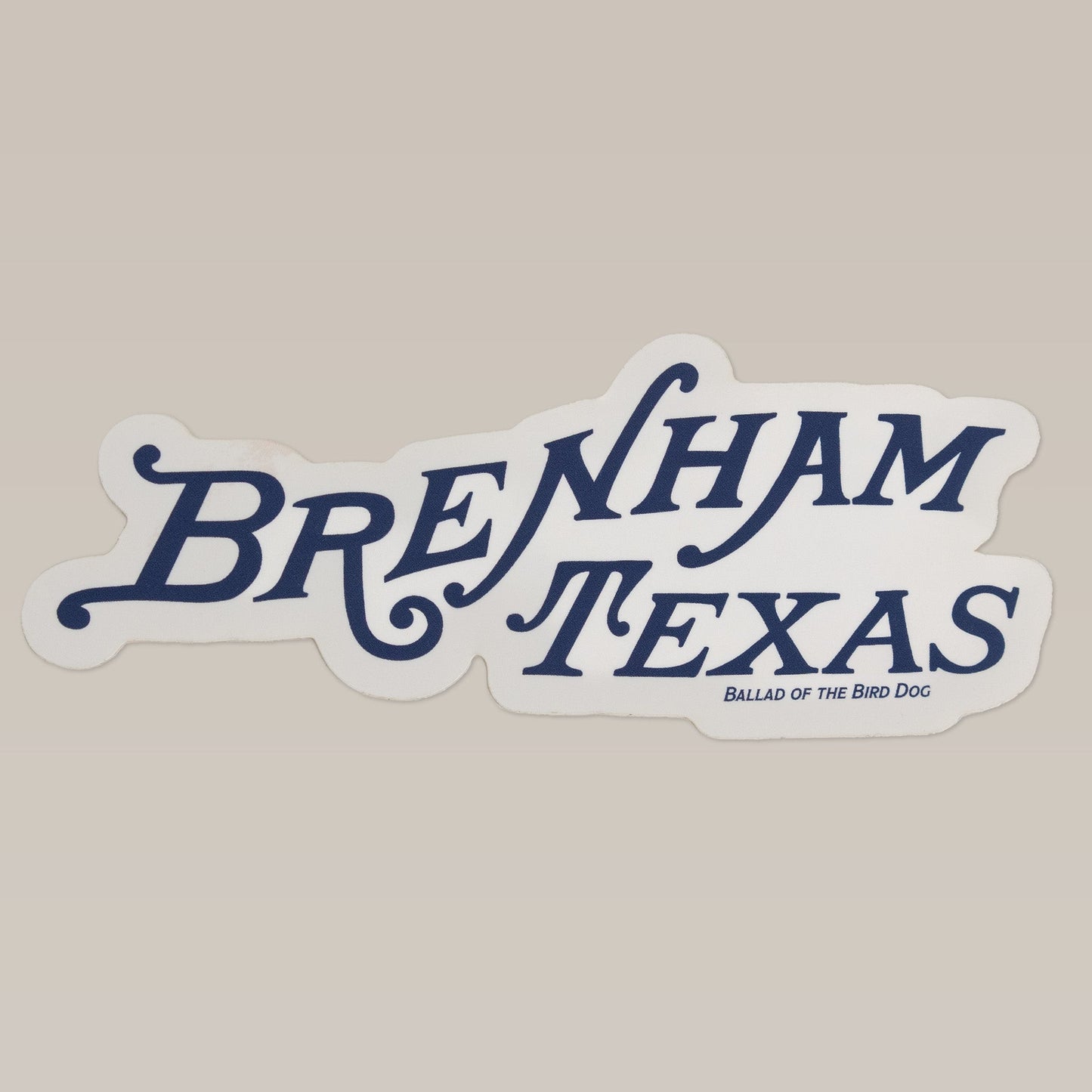 The Shop Sticker | Brenham Texas by Ballad of the Bird Dog features stylized "Brenham Texas" text with "Ballad of the Bird Dog" below on a light background—perfect as a versatile logo decal for any surface.