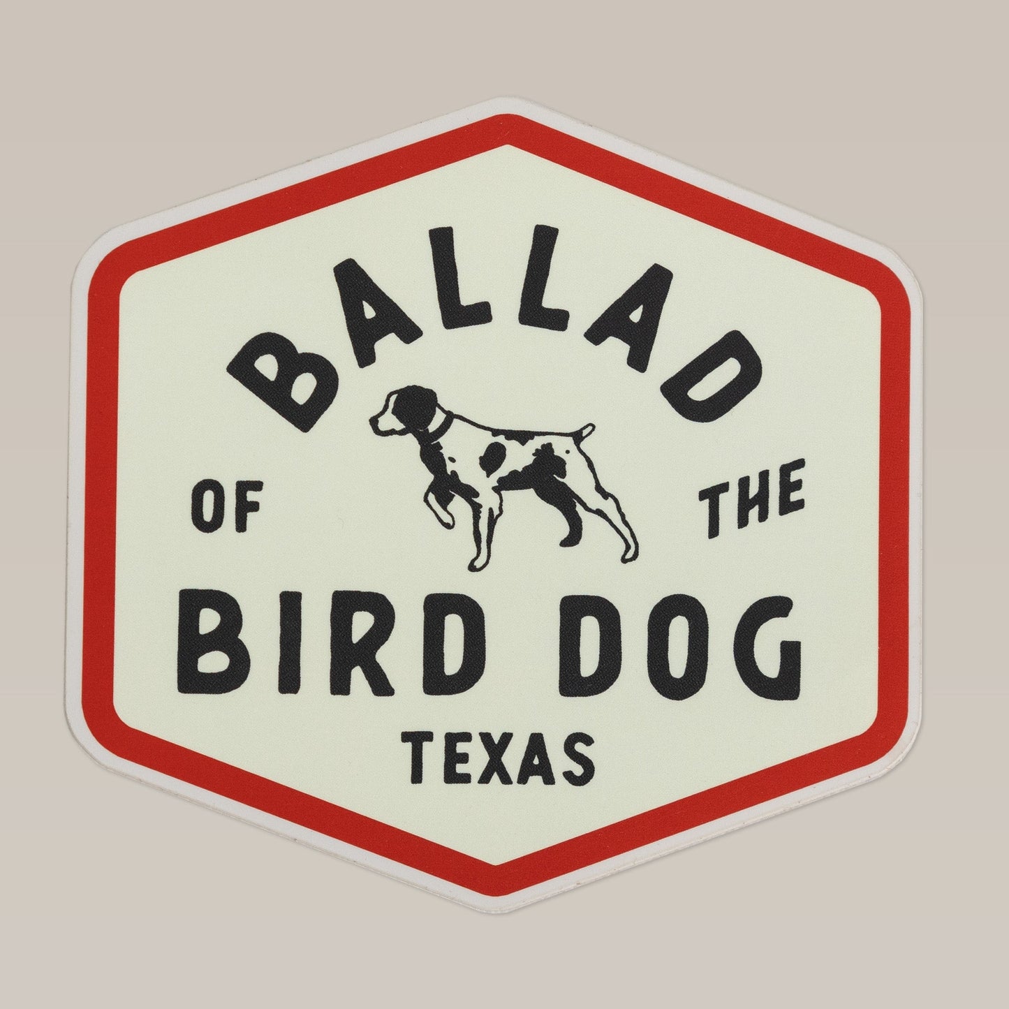 The Shop Sticker | Field Companion by Ballad of the Bird Dog features a hexagonal design with a pointing dog illustration and "Ballad of the Bird Dog Texas" text—ideal for showing brand loyalty or adding a unique flair to your gear.
