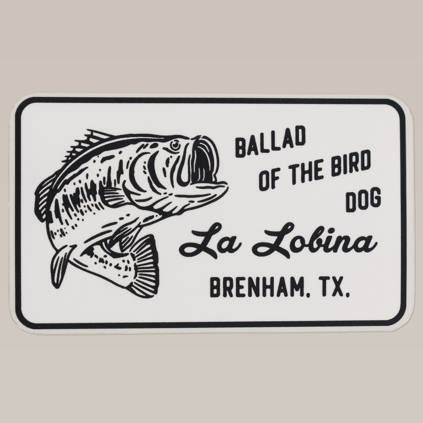 Show your love for bass fishing with the Shop Sticker | La Lobina by Ballad of the Bird Dog. Featuring a black and white largemouth bass and “La Lobina Brenham, TX,” it’s perfect for any fishing enthusiast.