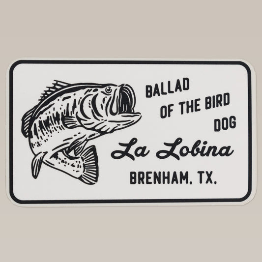 Show your love for bass fishing with the Shop Sticker | La Lobina by Ballad of the Bird Dog. Featuring a black and white largemouth bass and “La Lobina Brenham, TX,” it’s perfect for any fishing enthusiast.