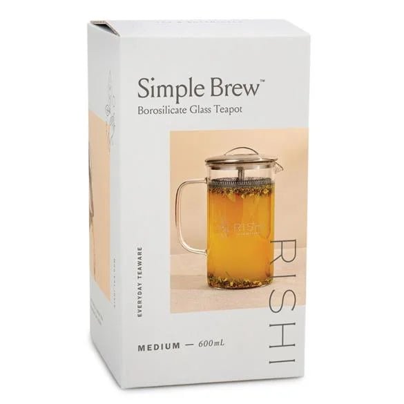 A retail box displays the Simple Brew | Medium Glass Teapot by Rishi (600mL), featuring an image of the teapot filled with tea and emphasizing its built-in strainer on the front.
