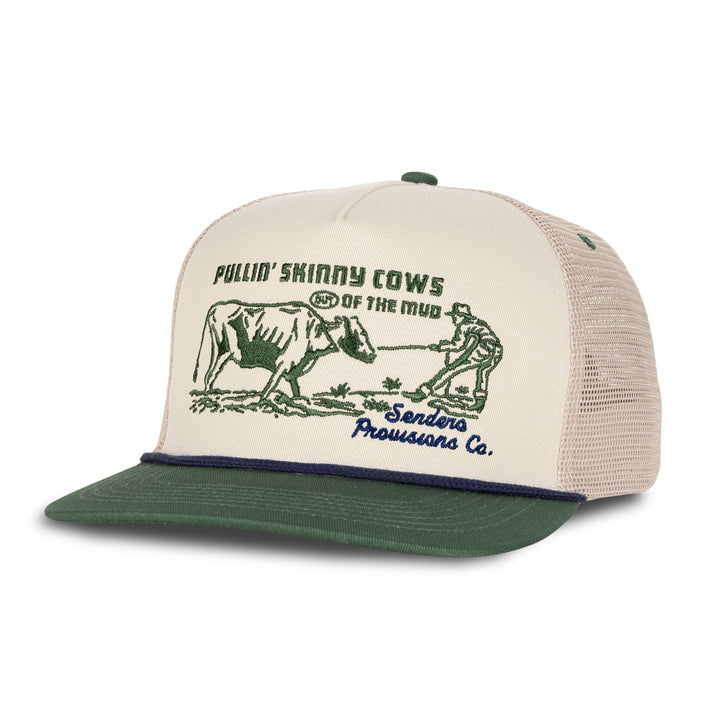 The Skinny Cows Hat by Sendero Provisions Co. is a beige and green trucker hat featuring Jack pulling skinny cows and the phrase "PULLIN’ SKINNY COWS OUT OF THE MUD - Senders Provisions Co." on the front.