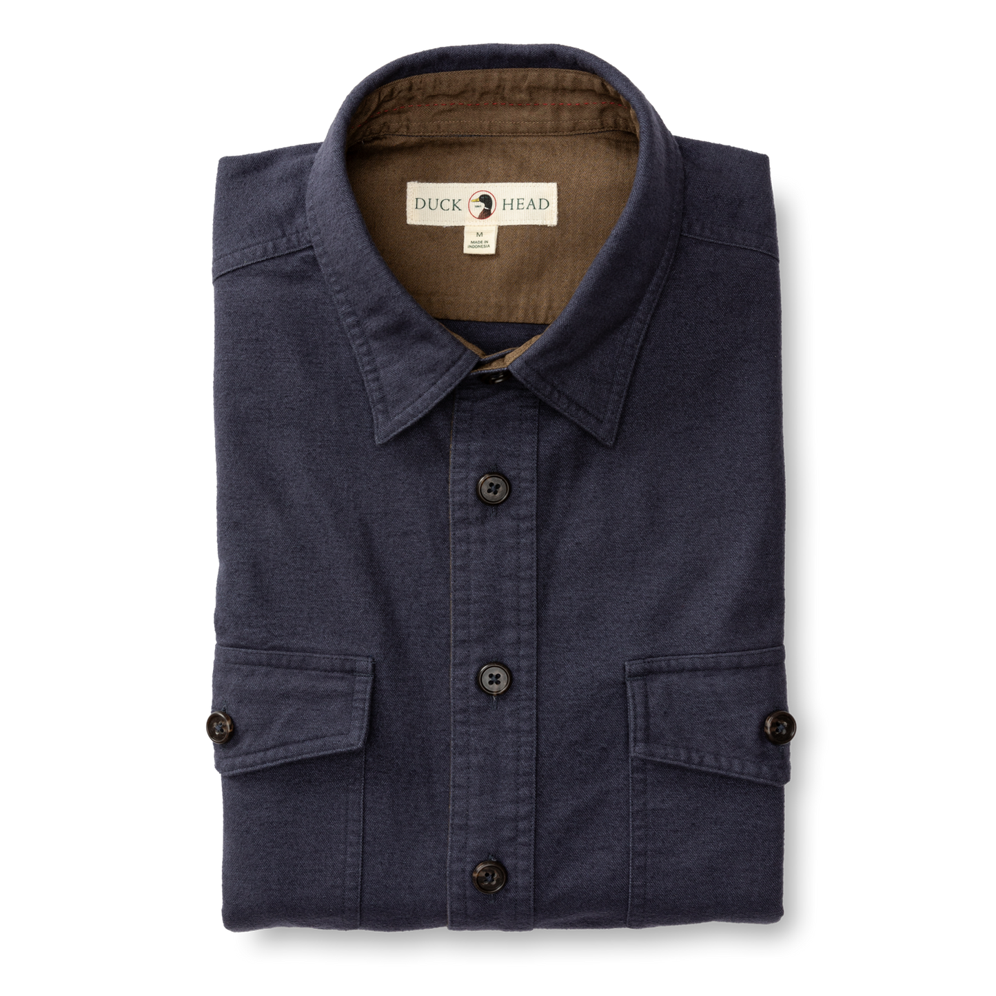 The Slater Moleskin Overshirt by Duck Head is a neatly folded navy blue shirt with two front pockets and a signature label on the collar, adding rugged style to your wardrobe.