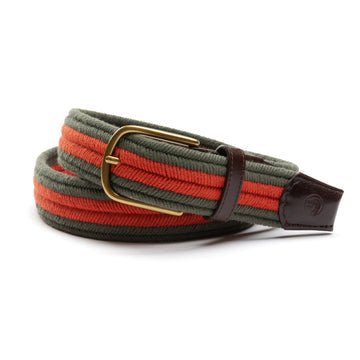 The Striped Braided Belt by Duck Head features green and orange cotton braids, a brass buckle, and dark brown leather ends—a classic belt made in the USA.