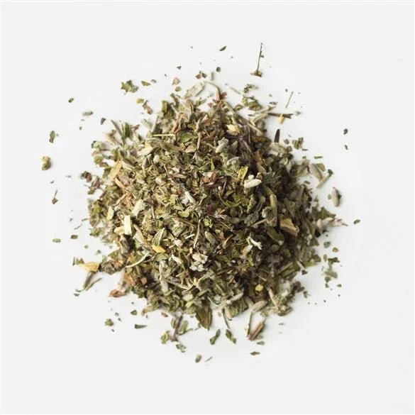 A small pile of dried, chopped herbs on a white background—Rishi’s Lavender Mint Tea is perfect for brewing a calming, soothing herbal blend.