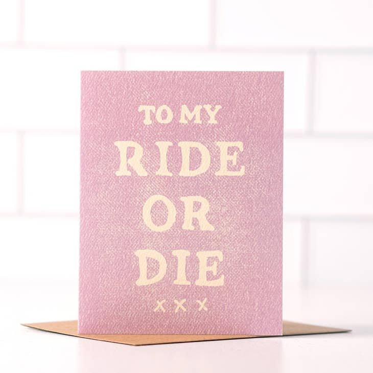 The “To My Ride Or Die” card by Daydream Prints features "TO MY RIDE OR DIE xxx" in white on pink and comes with a brown envelope—an ideal friendship card for your closest confidant.